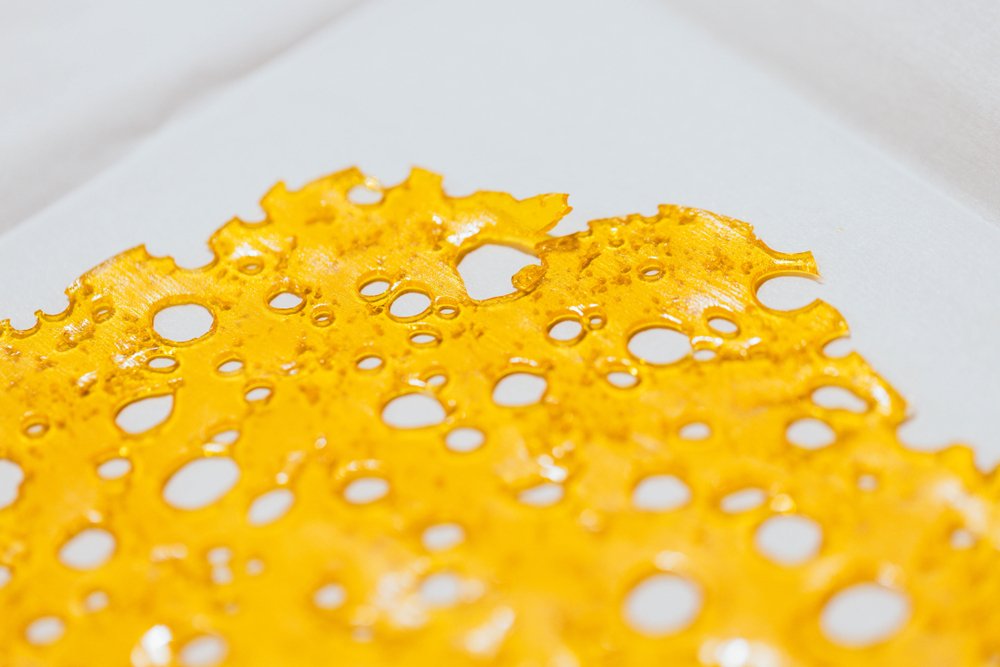 A plate of shatter wax with a high terpene content from Chronic Creations
